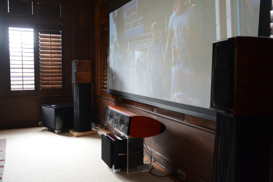 A REL subwoofer connected to a center channel speaker.